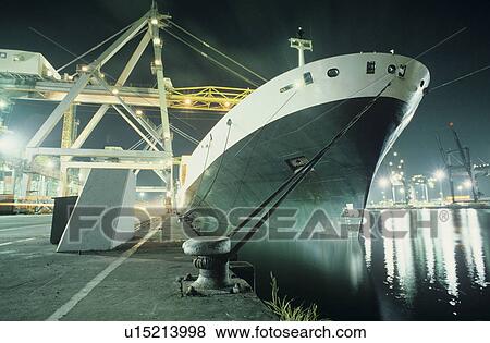 Containership being loaded in dock at night View Large Photo Image Stock Photo - Containership being loaded in dock at night. Fotosearch