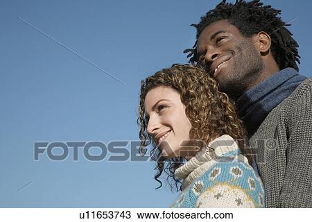 Couple against sky low angle view View Large Photo Image Stock Image - Couple against sky low angle view. Fotosearch