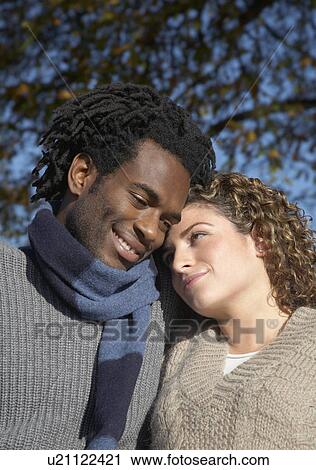 Couple cuddling outdoors View Large Photo Image Stock Image - Couple cuddling outdoors. Fotosearch