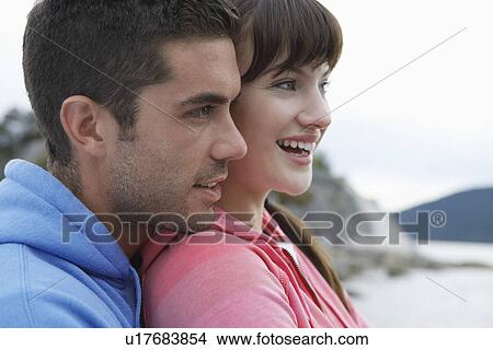 Couple embracing at ocean smiling close-up View Large Photo Image Picture - Couple embracing at ocean smiling close-up. Fotosearch