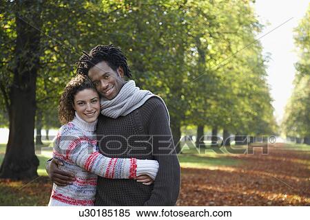 Stock Photography - Couple embracing in park. Fotosearch