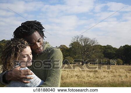 Couple hugging outdoors View Large Photo Image Stock Image - Couple hugging outdoors. Fotosearch