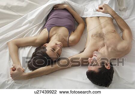 Couple lying in bed view from above View Large Photo Image Stock Image - Couple lying in bed view from above. Fotosearch