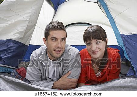 Stock Image - Couple lying side by side in tent portrait. Fotosearch