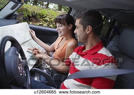 Couple observing map in car View Large Photo Image Stock Photography - Couple observing map in car. Fotosearch