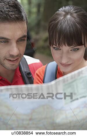 Couple observing map outdoors close-up View Large Photo Image Picture - Couple observing map outdoors close-up. Fotosearch