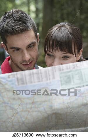 Couple observing map outdoors close-up View Large Photo Image Stock Image - Couple observing map outdoors close-up. Fotosearch