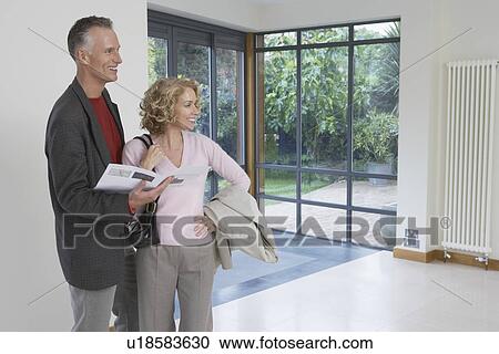 Couple observing new property View Large Photo Image Stock Image - Couple observing new property. Fotosearch