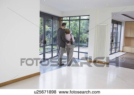 Couple observing new property View Large Photo Image Stock Photo - Couple observing new property. Fotosearch