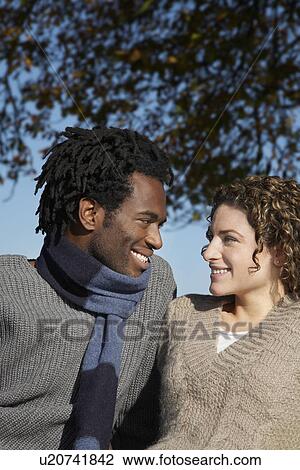Couple outdoors looking in eyes View Large Photo Image Stock Image - Couple outdoors looking in eyes. Fotosearch
