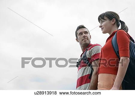 Couple outdoors low angle view View Large Photo Image Stock Photo - Couple outdoors low angle view. Fotosearch
