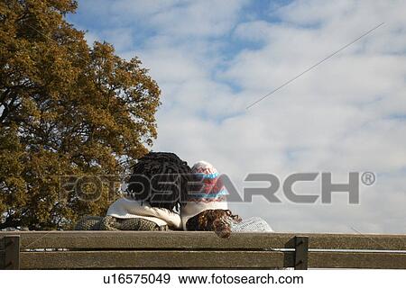 Couple sitting on bench back view View Large Photo Image Stock Photo - Couple sitting on bench back view. Fotosearch