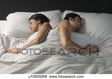 Stock Photo - Couple sleeping in bed. Fotosearch