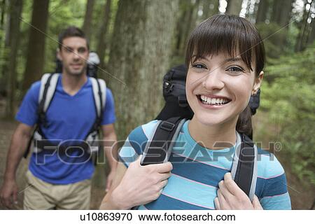 Couple smiling in forest portrait View Large Photo Image Stock Image - Couple smiling in forest portrait. Fotosearch