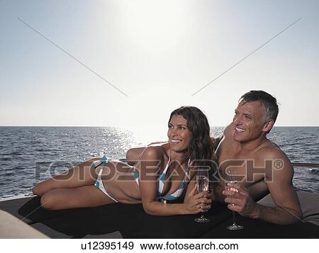 Couple Sunbathing on Boat View Large Photo Image Stock Photo - Couple Sunbathing on Boat. Fotosearch