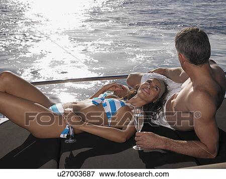 Couple Sunbathing on Boat View Large Photo Image Stock Photo - Couple Sunbathing on Boat. Fotosearch