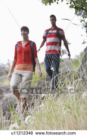Couple walking in countryside View Large Photo Image Stock Photo - Couple walking in countryside. Fotosearch