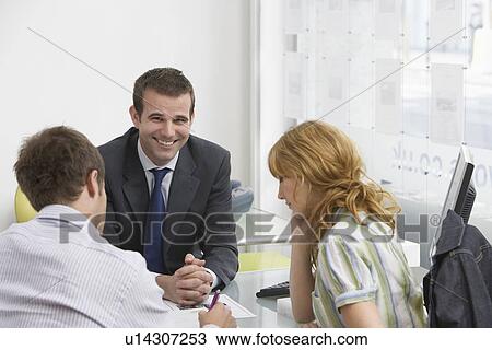Couple with real estate agent in office man writing View Large Photo Image Stock Image - Couple with real estate agent in office man writing. Fotosearch