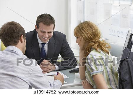 Couple with real estate agent in office man writing View Large Photo Image Stock Image - Couple with real estate agent in office man writing. Fotosearch