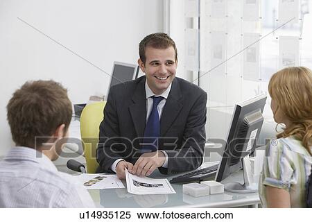 Couple with real estate agent in office View Large Photo Image Stock Photography - Couple with real estate agent in office. Fotosearch
