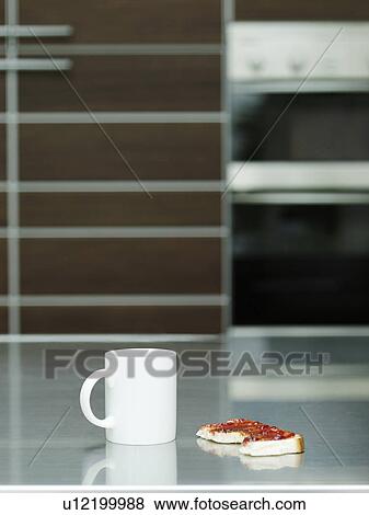 Stock Photo - Cup and toast with jam on table indoors. Fotosearch