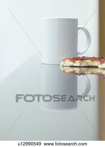 Cup and toast with jam on table surface view View Large Photo Image Stock Photo - Cup and toast with jam on table surface view. Fotosearch