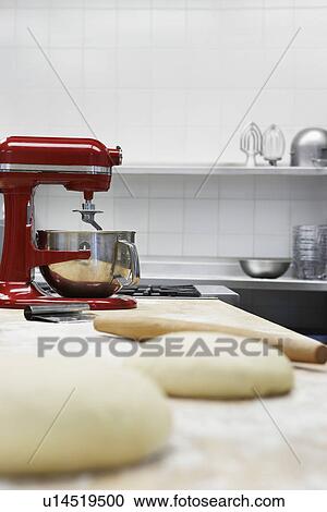 Dough on wooden board beside dough mixer in kitchen View Large Photo Image Stock Image - Dough on wooden board beside dough mixer in kitchen. Fotosearch