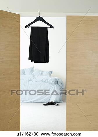 Dress on hanger in doorway of bedroom View Large Photo Image Stock Image - Dress on hanger in doorway of bedroom. Fotosearch