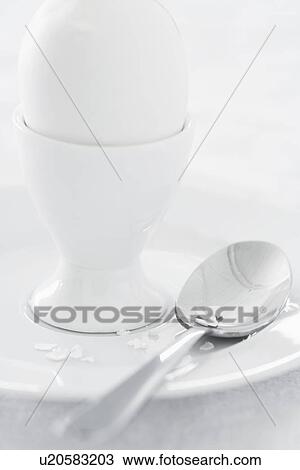Egg in egg cup on saucer studio shot View Large Photo Image Stock Image - Egg in egg cup on saucer studio shot. Fotosearch