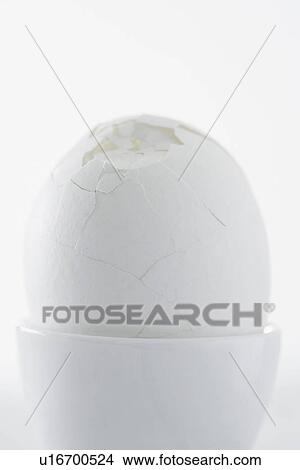 Egg with broken shell in egg cup close up studio shot View Large Photo Image Picture - Egg with broken shell in egg cup close up studio shot. Fotosearch