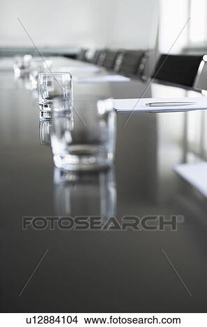 Empty glasses on conference room table View Large Photo Image Picture - Empty glasses on conference room table. Fotosearch