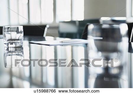 Stock Photograph - Empty glasses on conference room table. Fotosearch
