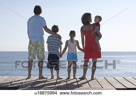 Family with three children (2-11) on jetty View Large Photo Image Picture - Family with three children (2-11) on jetty. Fotosearch