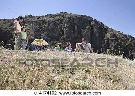 Family with three children (7-12) camping on mountain top View Large Photo Image Stock Image - Family with three children (7-12) camping on mountain top. Fotosearch
