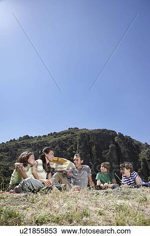Stock Image - Family with three children (7-12) camping on mountain top. Fotosearch
