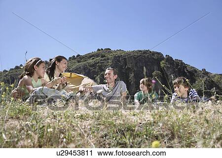 Family with three children (7-12) camping on mountain top View Large Photo Image Stock Image - Family with three children (7-12) camping on mountain top. Fotosearch