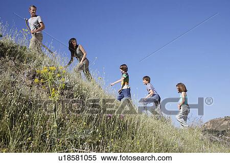 Family with three children (7-12) hiking side view View Large Photo Image Stock Photography - Family with three children (7-12) hiking side view. Fotosearch