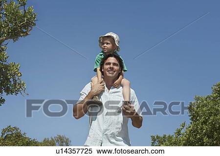 Farther carrying boy (3-4) piggy back outdoors View Large Photo Image Stock Photography - Farther carrying boy (3-4) piggy back outdoors. Fotosearch