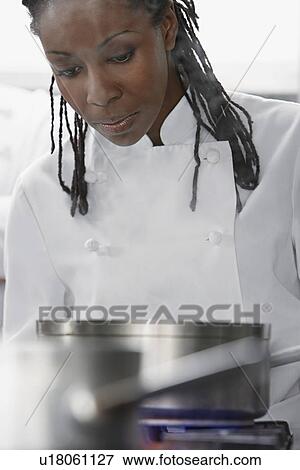 Female chef cooking in kitchen View Large Photo Image Stock Photo - Female chef cooking in kitchen. Fotosearch