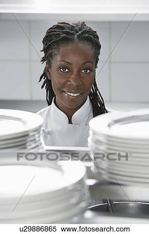 Female chef near stacked plates in kitchen portrait View Large Photo Image Stock Photography - Female chef near stacked plates in kitchen portrait. Fotosearch