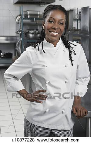 Female chef with hand on hip in kitchen portrait View Large Photo Image Stock Photo - Female chef with hand on hip in kitchen portrait. Fotosearch