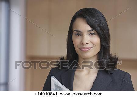 Stock Image - Female estate agent smiling portrait. Fotosearch