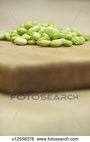 Fresh broad beans on wooden board close-up View Large Photo Image Stock Photograph - Fresh broad beans on wooden board close-up. Fotosearch