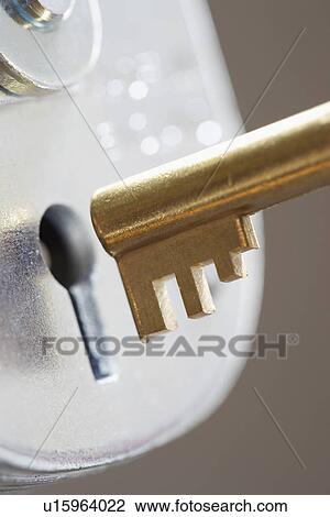 Golden key and padlock close-up View Large Photo Image Stock Image - Golden key and padlock close-up. Fotosearch