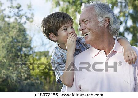 Grandfather with grandson (7-9) riding piggy back outdoors talking View Large Photo Image Stock Photography - Grandfather with grandson (7-9) riding piggy back outdoors talking. Fotosearch
