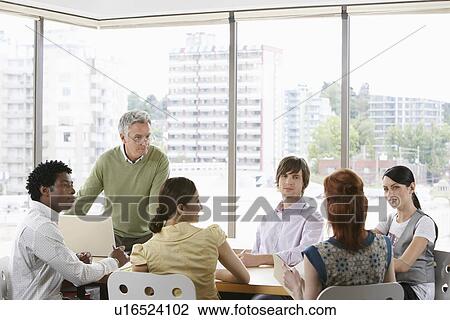 Stock Image - Group of business colleugues at office meeting. Fotosearch