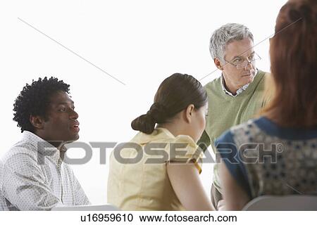 Stock Image - Group of business colleugues at office meeting. Fotosearch