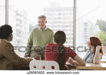 Group of business colleugues at office meeting View Large Photo Image Stock Image - Group of business colleugues at office meeting. Fotosearch