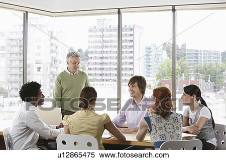 Stock Photography - Group of business colleugues at office meeting. Fotosearch