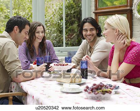 Group of young people sitting at verandah table View Large Photo Image Stock Image - Group of young people sitting at verandah table. Fotosearch